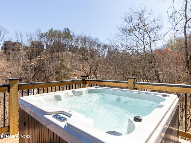 wooden deck with a hot tub