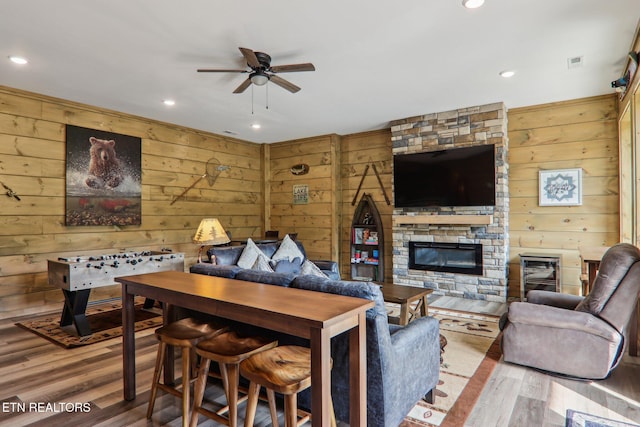 134 Jolene Way, Sevierville, TN 37876 - living room featuring a ceiling fan, wood walls, wood finished floors, a fireplace, and recessed lighting