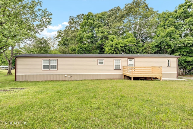 180 County Rd 853, Delano, TN 37325 - view of front of house with a wooden deck, a front yard, and view of wooded area