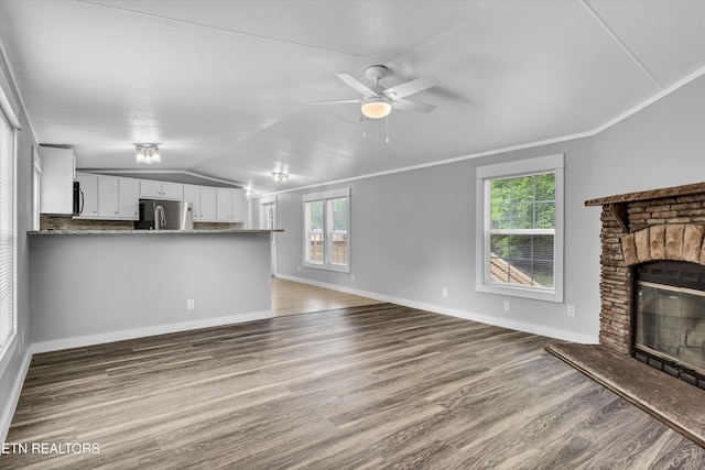 180 County Rd 853, Delano, TN 37325 - unfurnished living room with a fireplace, lofted ceiling, wood finished floors, baseboards, and a ceiling fan