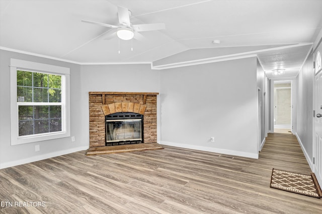 180 County Rd 853, Delano, TN 37325 - unfurnished living room with a stone fireplace, wood finished floors, baseboards, ceiling fan, and lofted ceiling