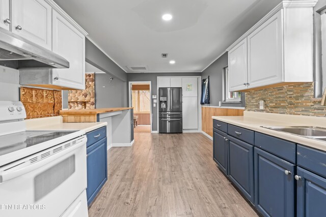 kitchen featuring white electric stove, stainless steel refrigerator with ice dispenser, blue cabinetry, under cabinet range hood, and white cabinetry