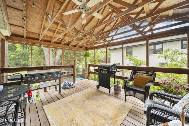 deck featuring area for grilling and ceiling fan