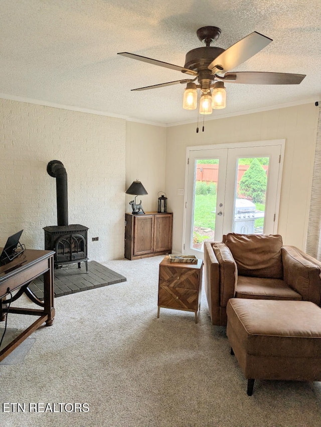 131 Chestnut Hill Rd, Oak Ridge, TN 37830 - living area with a wood stove, ceiling fan, a textured ceiling, ornamental molding, and carpet floors