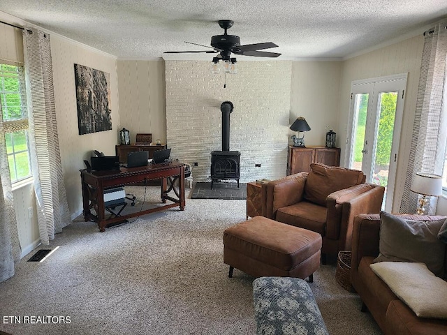 131 Chestnut Hill Rd, Oak Ridge, TN 37830 - sitting room with ornamental molding, a textured ceiling, plenty of natural light, a wood stove, and ceiling fan