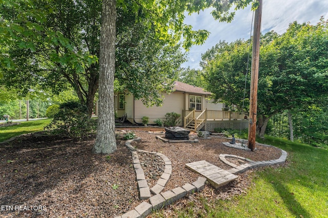 122 Mariners Dr, Crossville, TN 38558 - view of grassy yard with a wooden deck and an outdoor fire pit