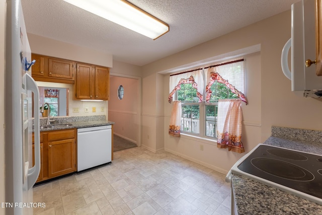 122 Mariners Dr, Crossville, TN 38558 - kitchen with white appliances, a sink, brown cabinetry, baseboards, and stone countertops