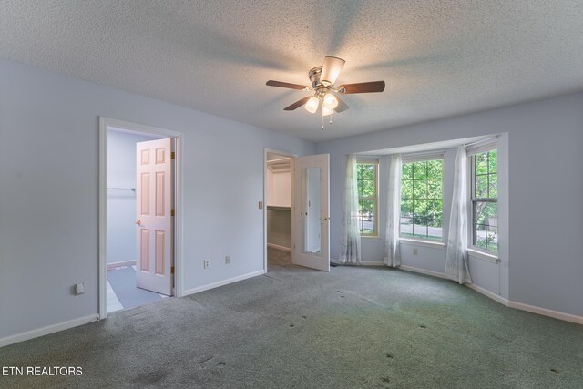 122 Mariners Dr, Crossville, TN 38558 - unfurnished bedroom with a spacious closet, carpet, a textured ceiling, baseboards, and ceiling fan