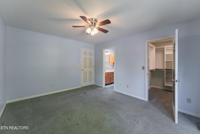 122 Mariners Dr, Crossville, TN 38558 - unfurnished bedroom featuring a walk in closet, dark carpet, baseboards, a closet, and ensuite bath