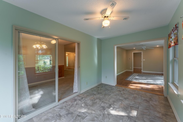122 Mariners Dr, Crossville, TN 38558 - empty room featuring a ceiling fan, a chandelier, and baseboards