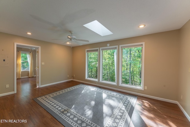 122 Mariners Dr, Crossville, TN 38558 - empty room featuring a skylight, wood finished floors, baseboards, a ceiling fan, and recessed lighting