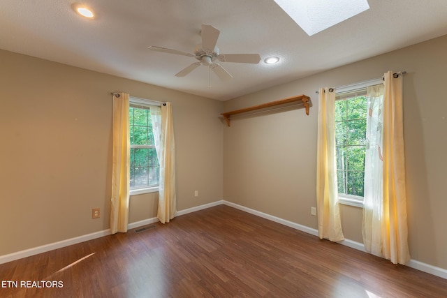 122 Mariners Dr, Crossville, TN 38558 - spare room featuring wood finished floors, a skylight, plenty of natural light, baseboards, and recessed lighting
