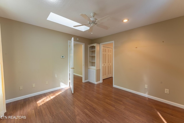 122 Mariners Dr, Crossville, TN 38558 - unfurnished room featuring a skylight, wood finished floors, baseboards, and a ceiling fan
