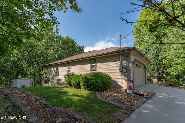 122 Mariners Dr, Crossville, TN 38558 - view of home's exterior featuring concrete driveway, a yard, and a garage