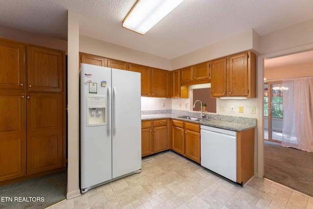 122 Mariners Dr, Crossville, TN 38558 - kitchen featuring white appliances, a sink, brown cabinetry, light stone countertops, and a textured ceiling