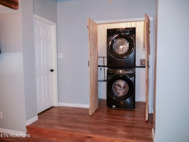 643 Airport Rd, Oakdale, TN 37829 - laundry room with stacked washing machine and dryer, wood finished floors, and baseboards