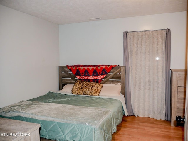643 Airport Rd, Oakdale, TN 37829 - bedroom featuring wood finished floors