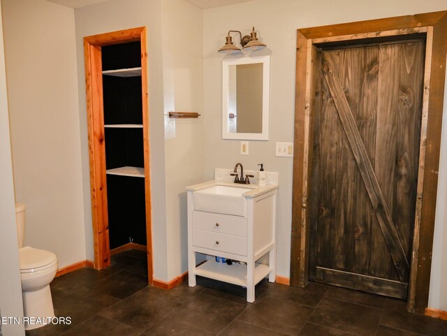 643 Airport Rd, Oakdale, TN 37829 - full bath with toilet, vanity, baseboards, and tile patterned floors