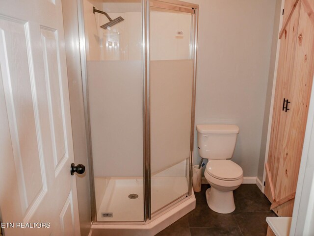 643 Airport Rd, Oakdale, TN 37829 - bathroom featuring a stall shower, toilet, tile patterned flooring, and baseboards