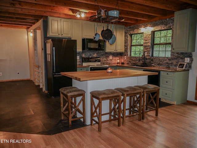 643 Airport Rd, Oakdale, TN 37829 - kitchen with black appliances, butcher block counters, a sink, a kitchen bar, and backsplash