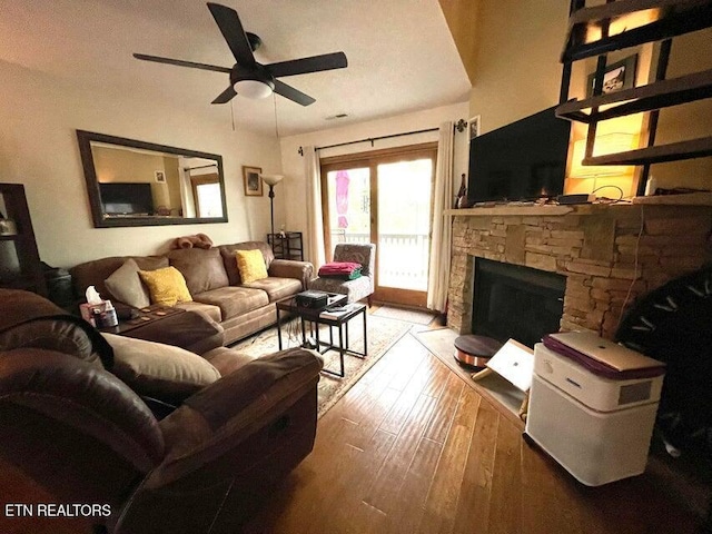 281 Moytoy Rd Unit 206, Crab Orchard, TN 37723 - living area with a ceiling fan, wood-type flooring, and a stone fireplace