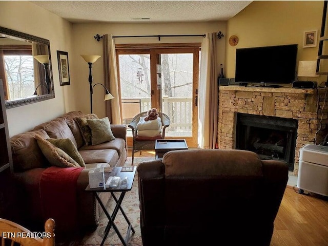 281 Moytoy Rd Unit 206, Crab Orchard, TN 37723 - living area with healthy amount of natural light, wood finished floors, a fireplace, and a textured ceiling