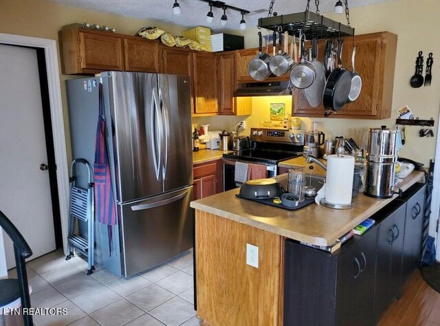 281 Moytoy Rd Unit 206, Crab Orchard, TN 37723 - kitchen featuring appliances with stainless steel finishes, under cabinet range hood, a peninsula, light countertops, and brown cabinets