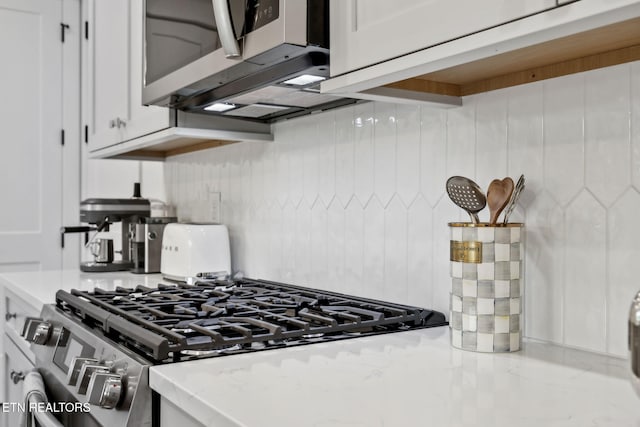 kitchen with appliances with stainless steel finishes and white cabinetry
