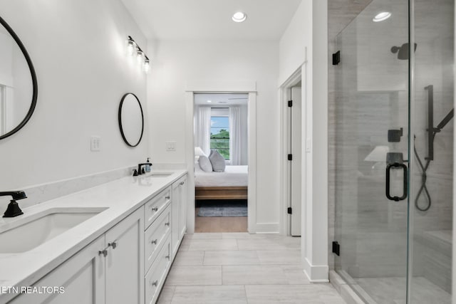 bathroom with a stall shower, double vanity, recessed lighting, connected bathroom, and baseboards