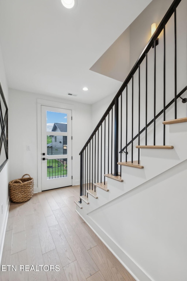 entryway featuring stairs, wood finished floors, recessed lighting, and baseboards