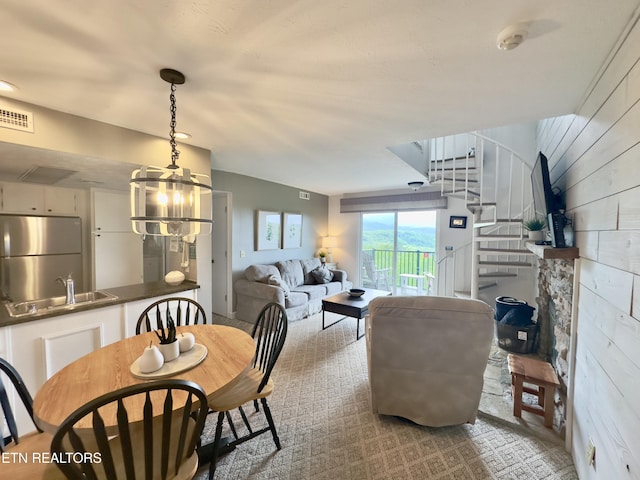 dining room featuring stairway and wooden walls