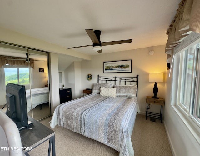 bedroom featuring carpet floors, a ceiling fan, baseboards, and a closet