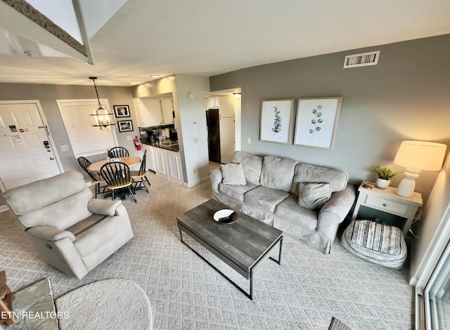 living room with light carpet and baseboards