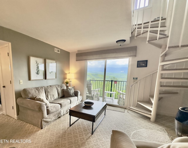 living room featuring stairway and plenty of natural light