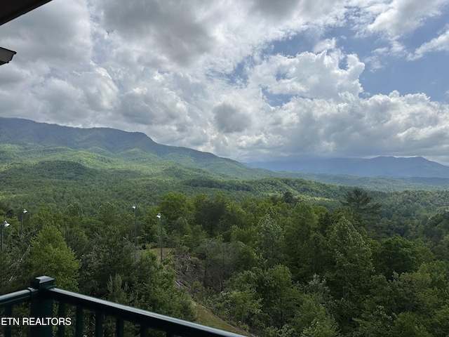 view of mountain background featuring a forest
