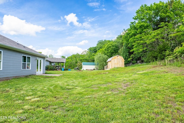 350 Hartfield Ln, Loudon, TN 37774 - view of green lawn with a storage unit and an outbuilding