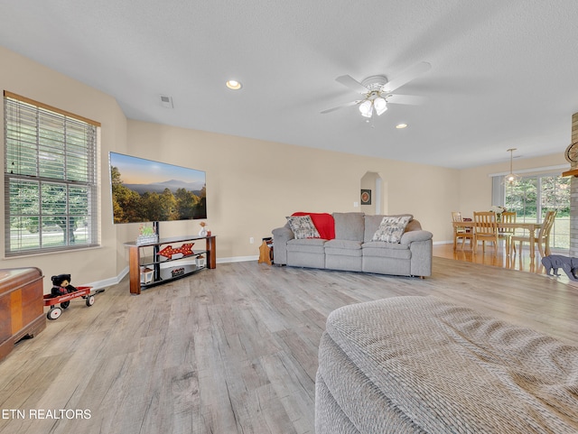 living area featuring wood finished floors, baseboards, ceiling fan, and recessed lighting