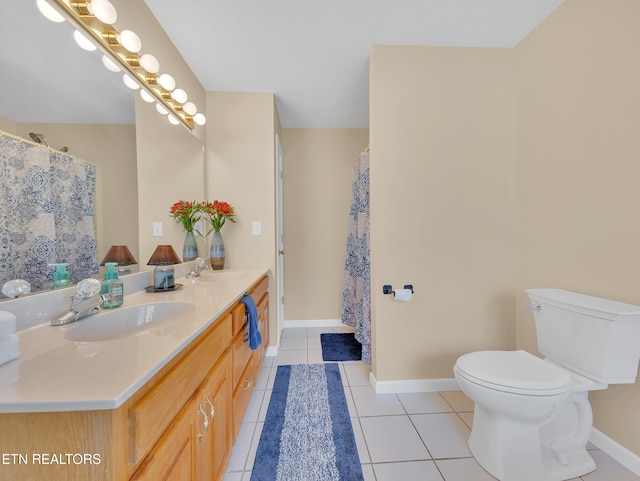 full bath with toilet, tile patterned flooring, baseboards, and double vanity