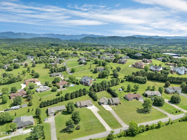 aerial view of residential area featuring a mountainous background
