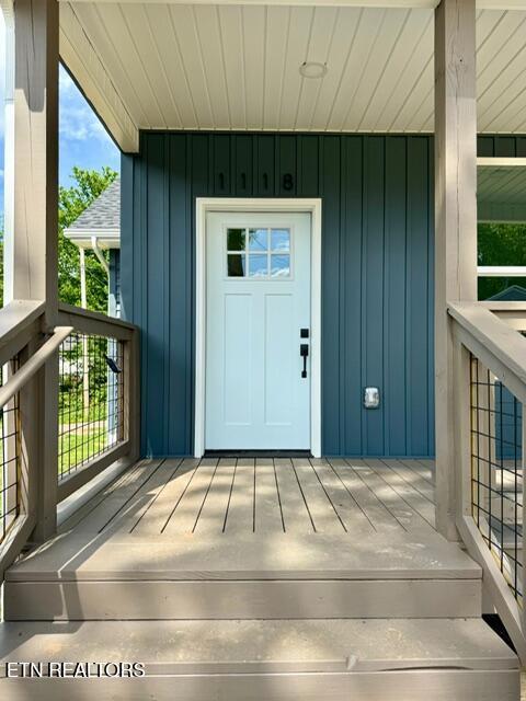 1118 NW Mercer St, Knoxville, TN 37921 - view of exterior entry featuring board and batten siding and covered porch