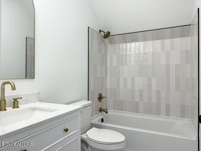 1118 NW Mercer St, Knoxville, TN 37921 - bathroom featuring toilet, vanity, bathing tub / shower combination, and lofted ceiling