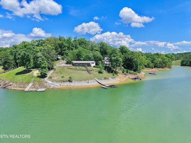 view from above of property with a large body of water and a heavily wooded area