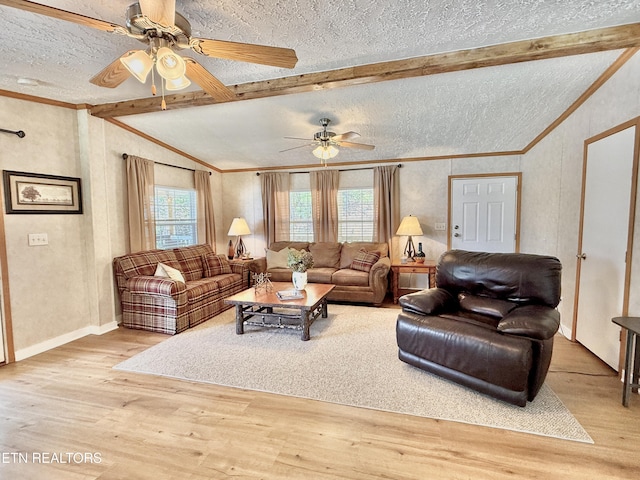 living area with a textured ceiling, ceiling fan, wood finished floors, crown molding, and baseboards