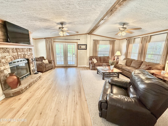 living room with ceiling fan, hardwood / wood-style floors, ornamental molding, healthy amount of natural light, and a textured ceiling