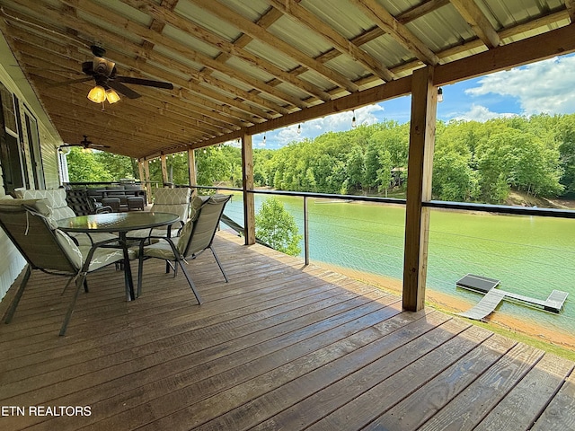 wooden deck with outdoor dining area and a ceiling fan