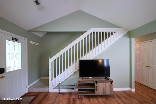 entrance foyer with lofted ceiling, baseboards, wood finished floors, and stairway