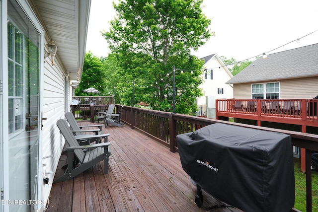 deck featuring a grill and outdoor dining space