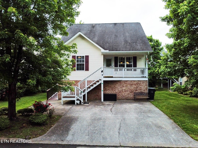 view of front of house featuring covered porch, a front lawn, and stairway