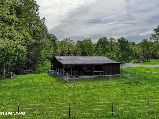 112 Auda Story, Jamestown, TN 38556 - back of house with an exterior structure, an outbuilding, metal roof, and a forest view