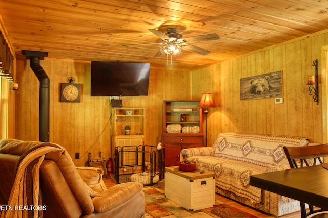 112 Auda Story, Jamestown, TN 38556 - living room with wood ceiling, wooden walls, a ceiling fan, and a wood stove